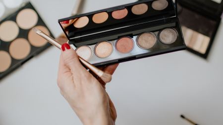 Hand hält Lidschattenpalette