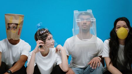 Zwei Männer und zwei Frauen mit lustigen DIY-Masken gegen das Coronavirus