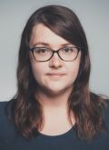 Portrait von Alexandra Koller - Frau mit braunen Haaren, Brille und T-Shirt